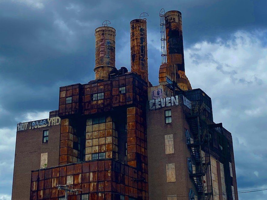 Old factory building covered in graffiti.